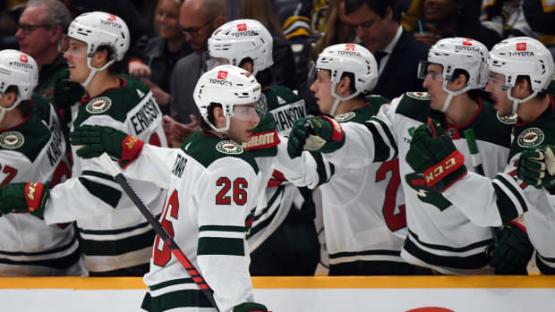 Caption: Feb 29, 2024; Nashville, Tennessee, USA; Minnesota Wild center Connor Dewar (26) celebrates with teammates after a goal during the first period against the Nashville Predators at Bridgestone Arena.